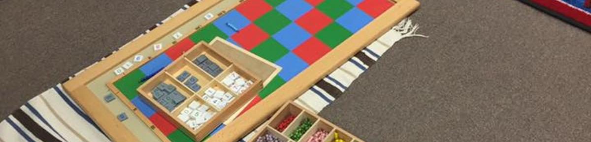 Montessori learning materials arranged on a classroom rug