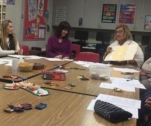 Parents gathered around a table at an MPAC meeting