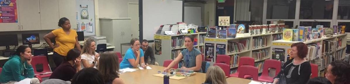 Parents gathered around a table at an MPAC meeting